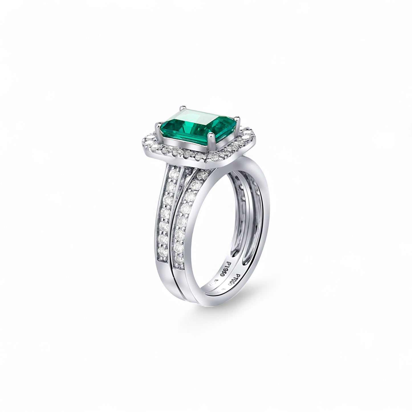 Silver ring with a green gemstone on a white background