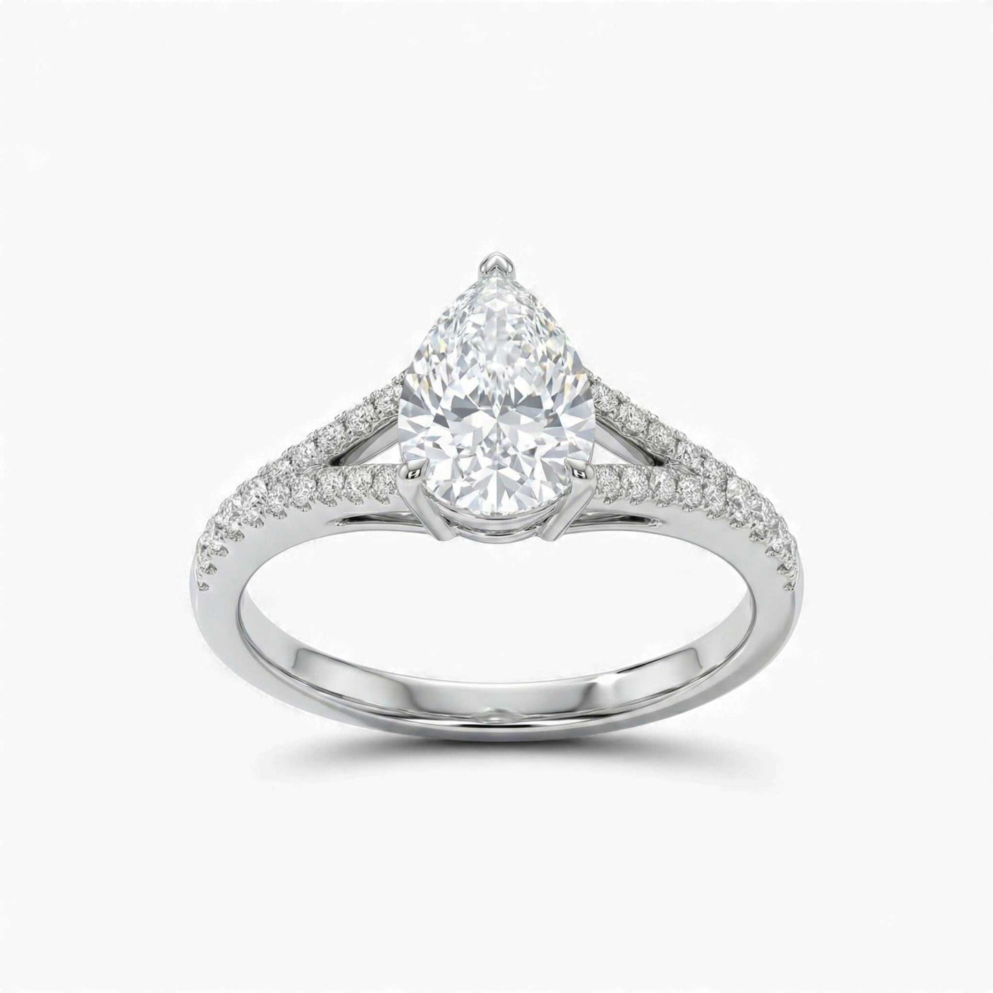 Diamond ring with a pear-shaped center stone on a white background