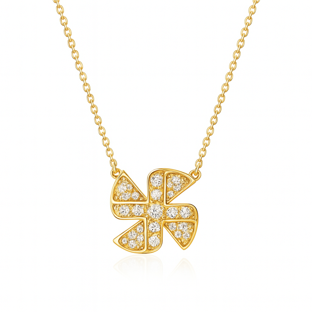 Gold necklace with a diamond-encrusted clover pendant on a white background
