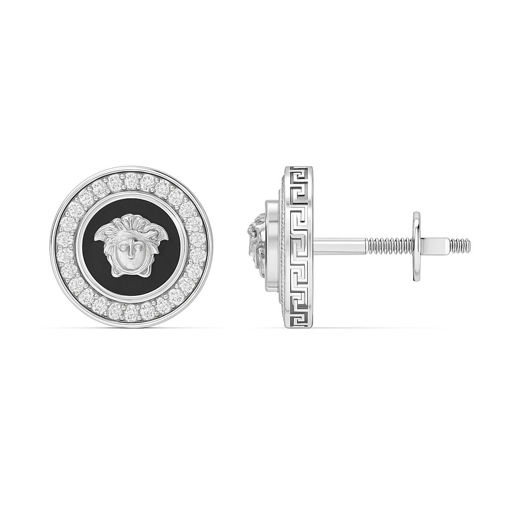 Silver earring with black center and gemstones on a white background