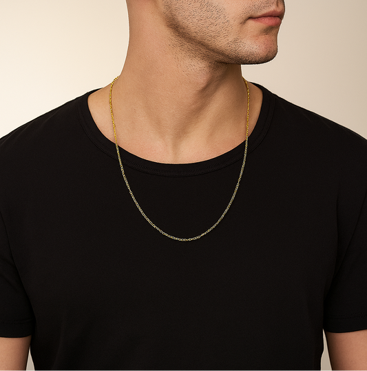 Man wearing a black t-shirt and gold chain necklace against a beige background