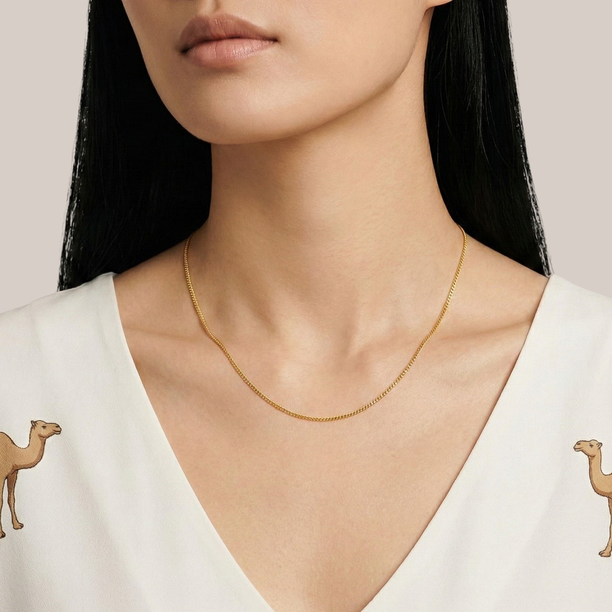 Gold necklace on a model with a white background