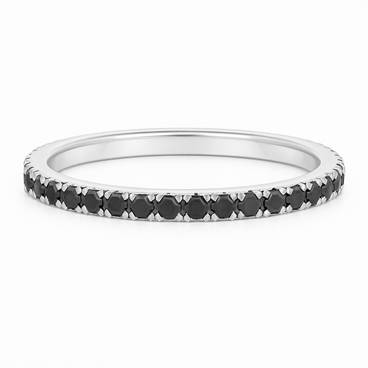Silver ring with black gemstones on a white background