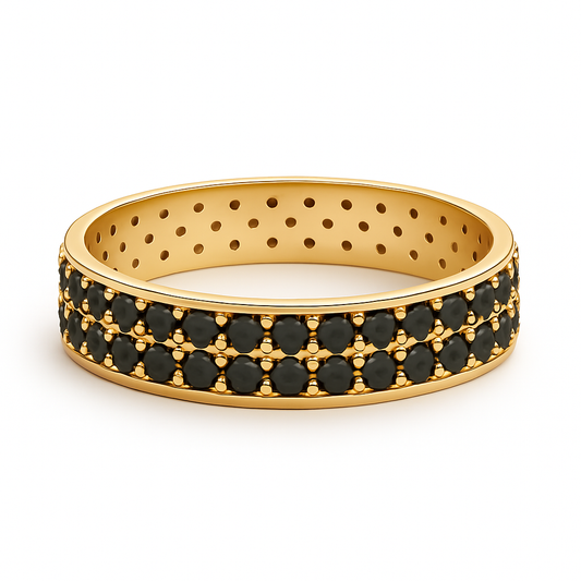 Gold ring with black gemstones on a white background