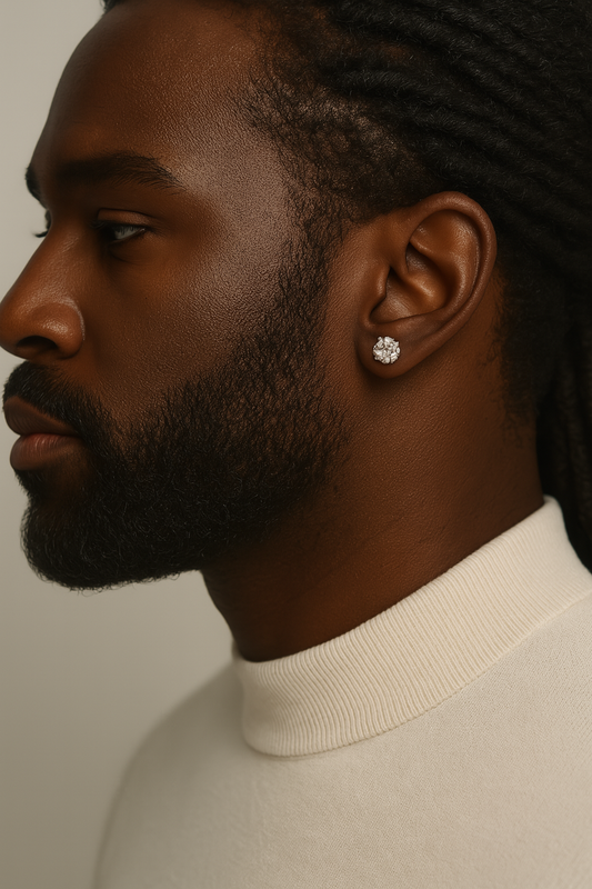 Man wearing a diamond earring against a neutral background