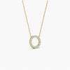 Gold necklace with a circular pendant on a white background