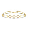 An 18 karat gold bracelet featuring a geometric pattern with three clovers, adorned with diamonds.