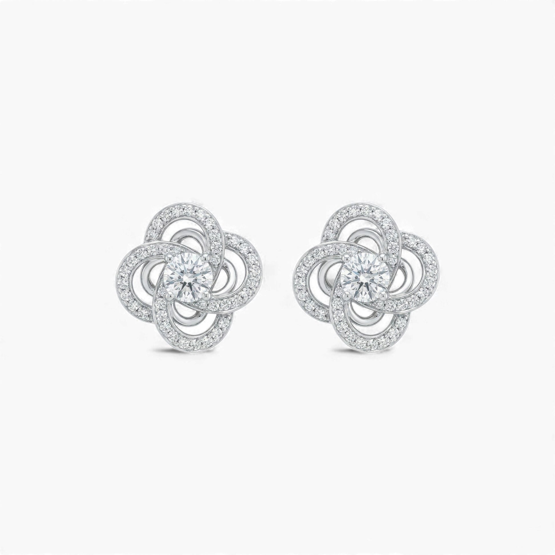 Pair of silver flower-shaped earrings on a white background