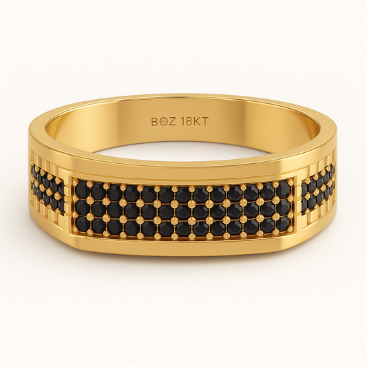 Gold ring with black gemstones on a white background