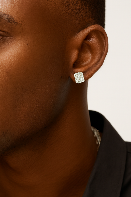 Close-up of a person wearing a silver earring on a neutral background