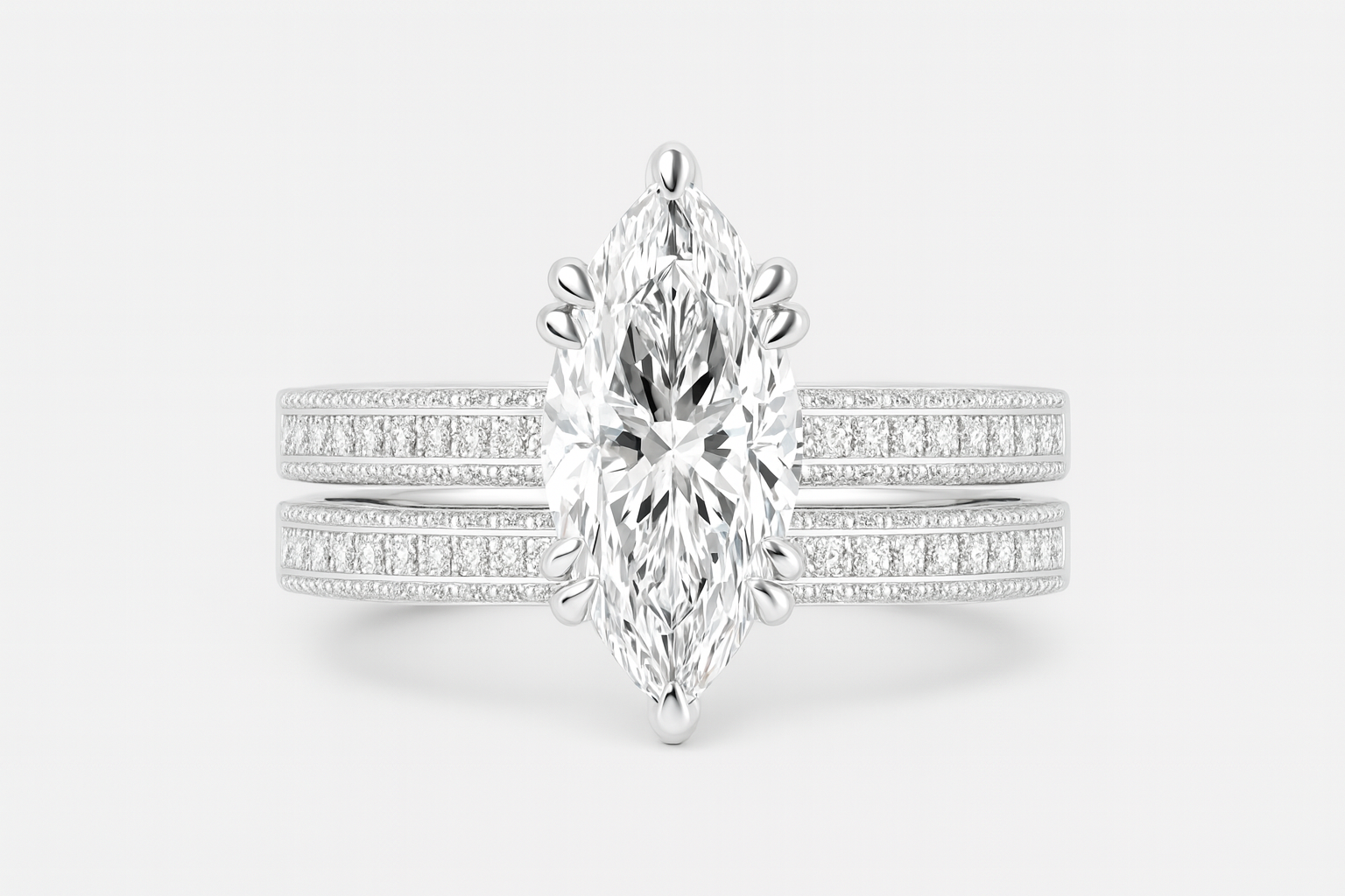 Diamond ring with a marquise-shaped center stone on a white background