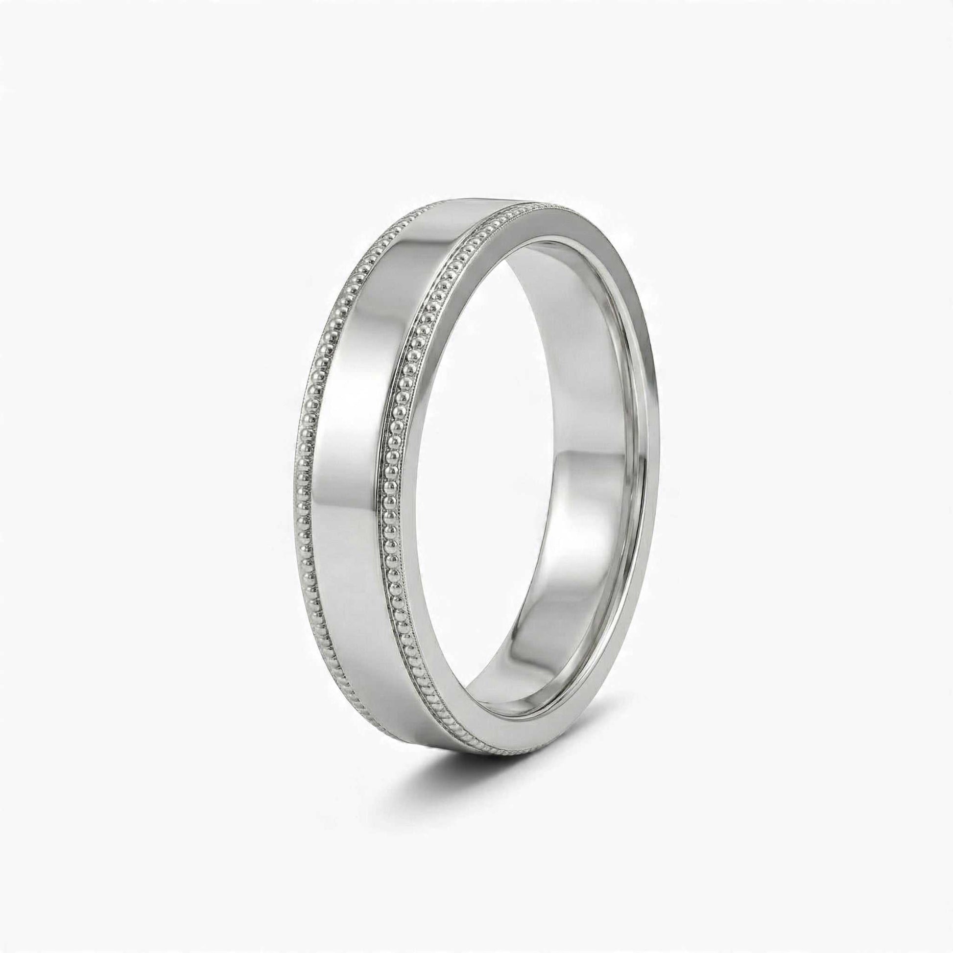 Silver ring with detailed design on a white background