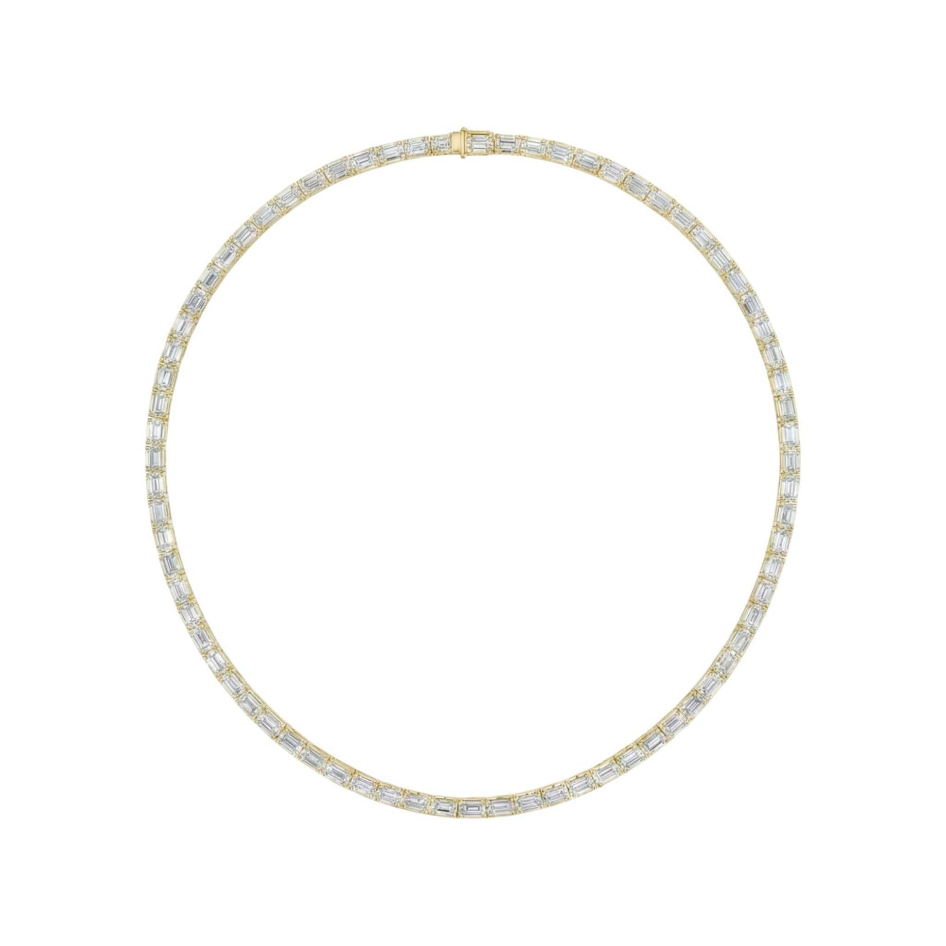 Gold necklace with clear stones on a white background