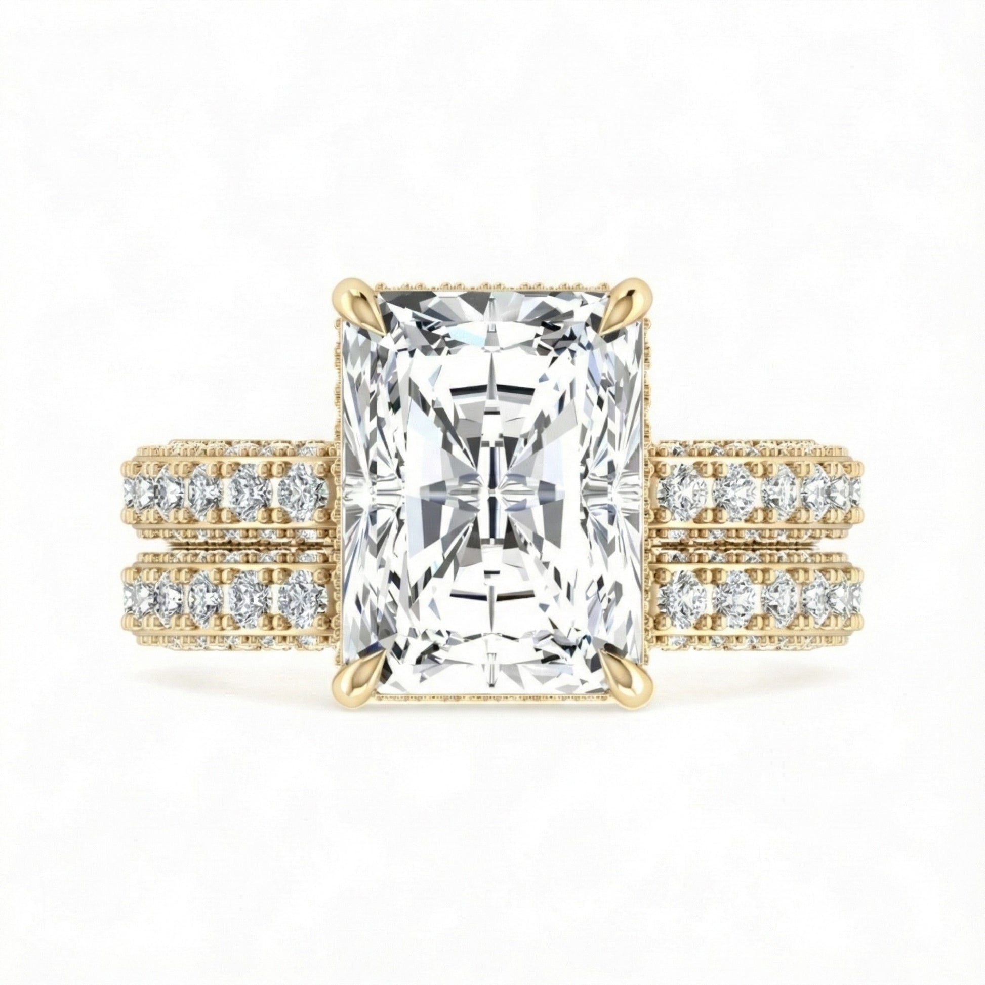 Gold ring with a large diamond and smaller diamonds on the band against a white background