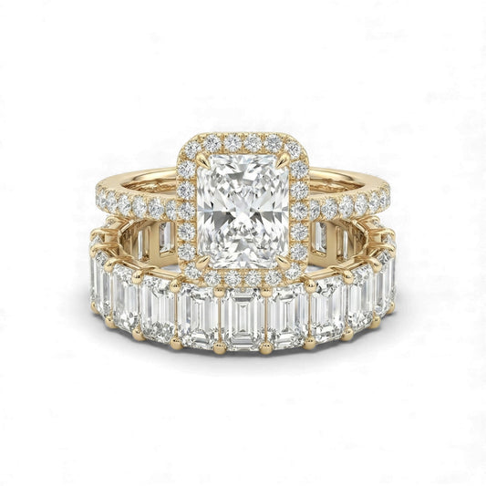 Gold ring with emerald-cut diamond and baguette diamonds on a white background