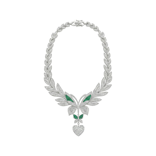 Ornate silver necklace with green gemstones on a white background