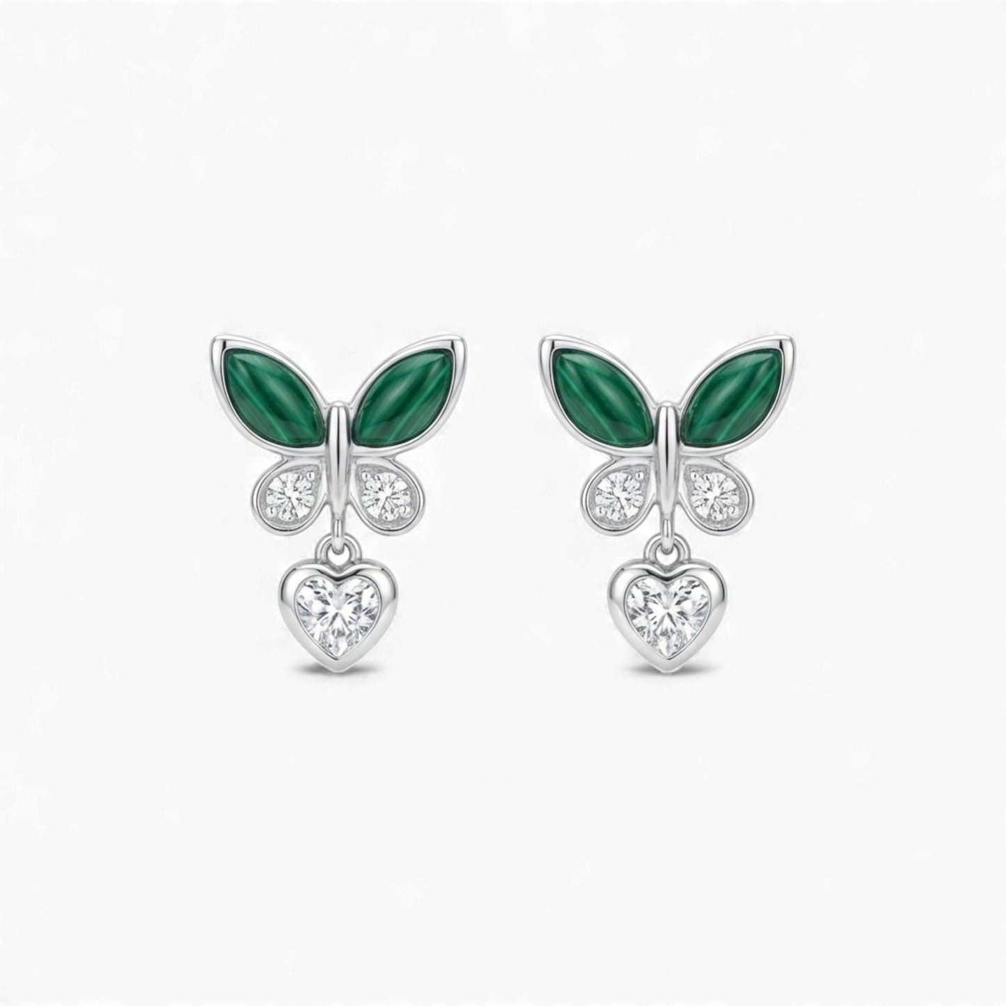 Pair of earrings with green leaf-like designs and heart-shaped elements on a white background