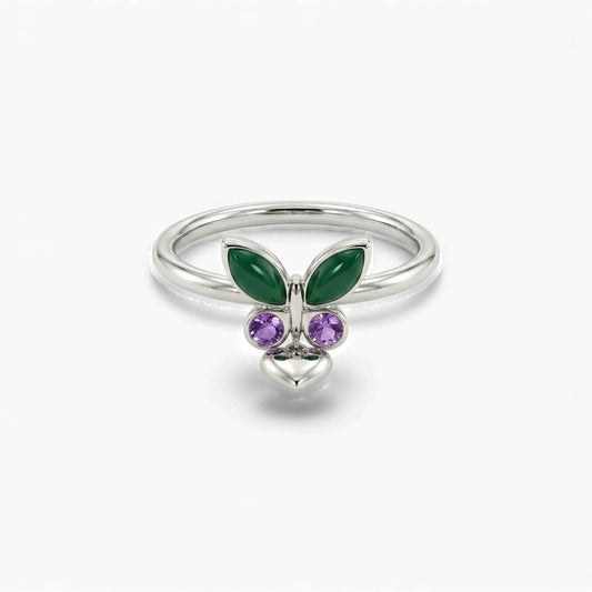 Silver ring with green butterfly wings and purple gemstones on a white background