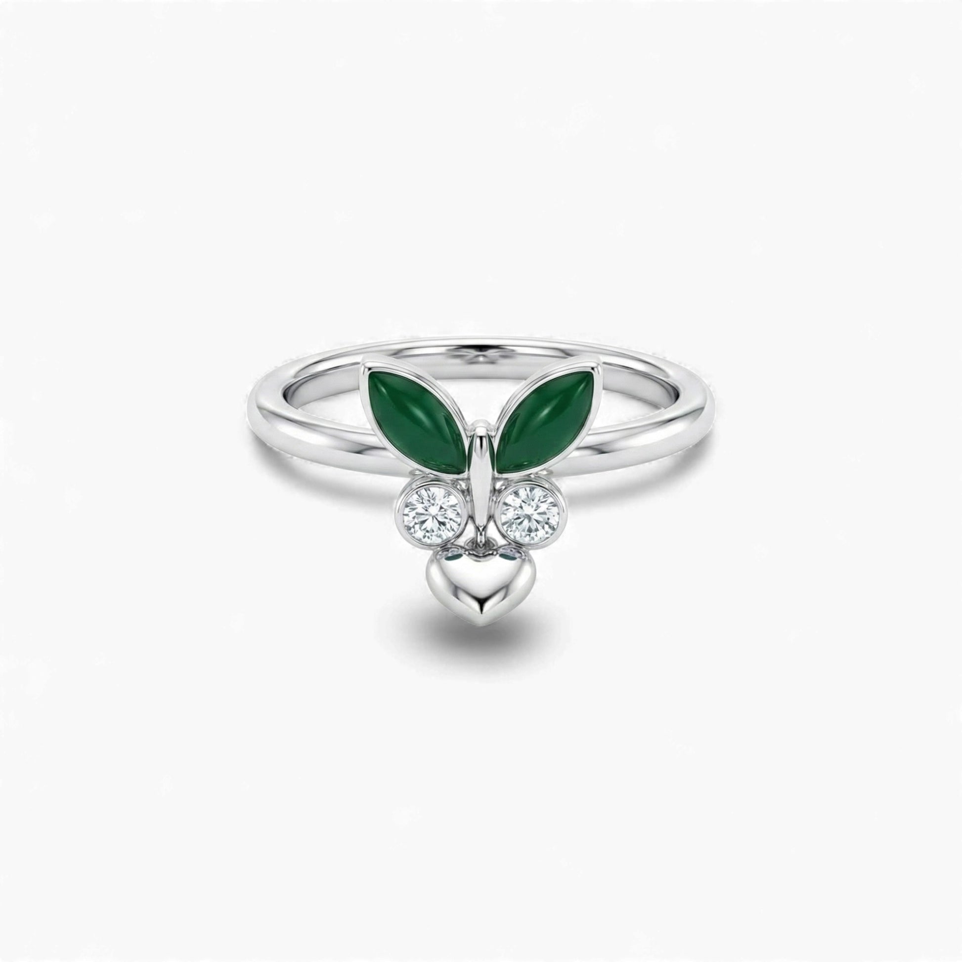 Silver ring with green gemstones and heart design on a white background
