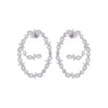 A pair of silver-tone hoop earrings adorned with small clear stones and openwork scroll motifs, shown on a plain white background.
