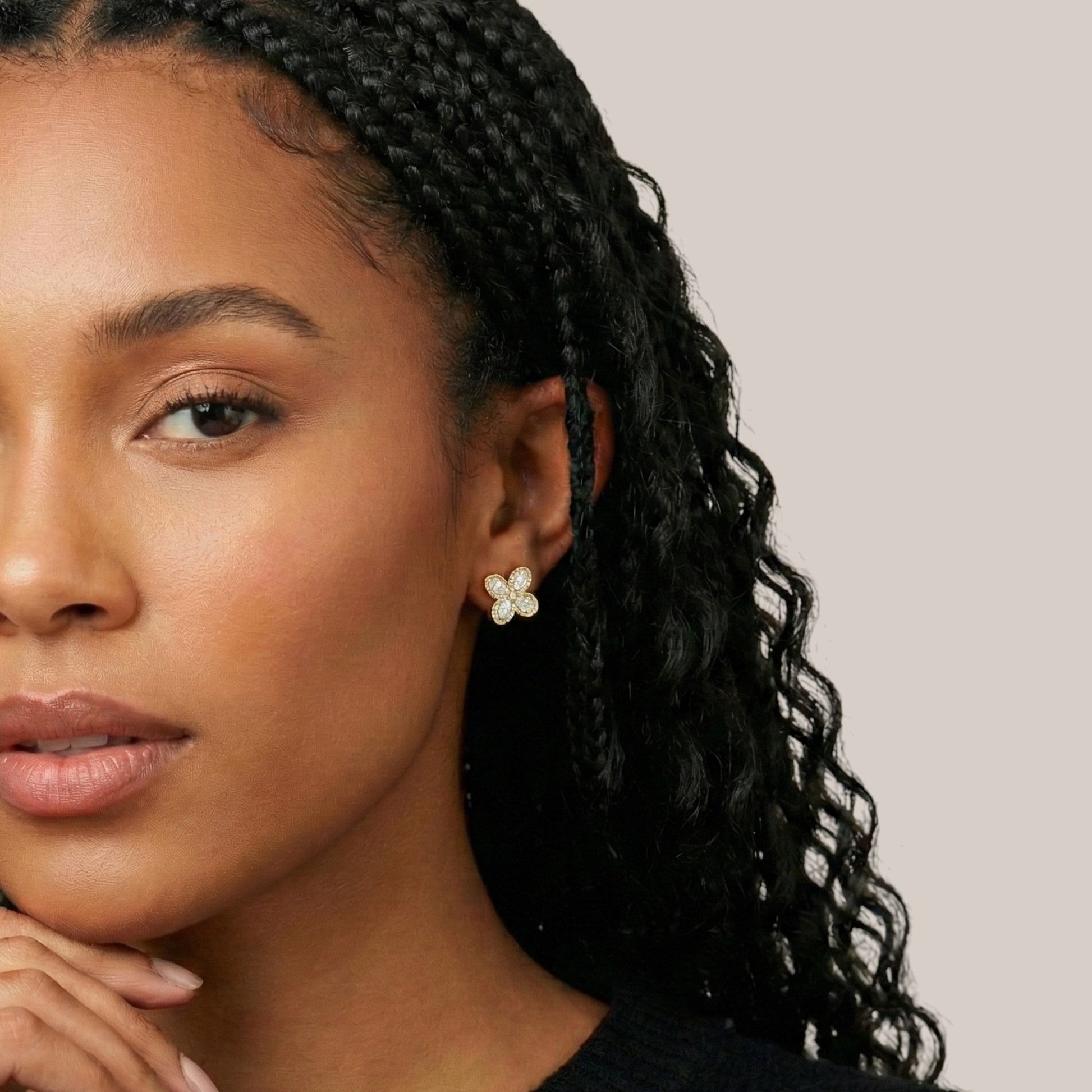 Woman wearing a floral earring with a neutral background