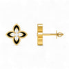 Gold and black floral earring on a white background