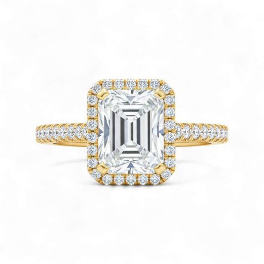 Gold and diamond ring with a large central gemstone on a white background