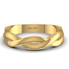 Gold ring with braided design on a white background
