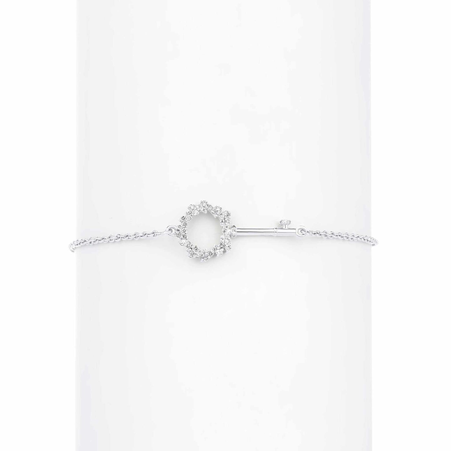 Silver bracelet with a heart-shaped clasp on a white background