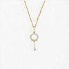 Gold key-shaped pendant necklace on a white background