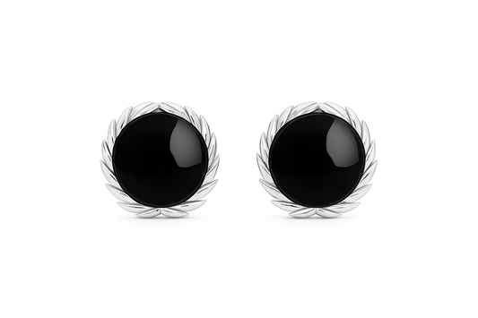 Pair of black earrings with silver leaf-like designs on a white background