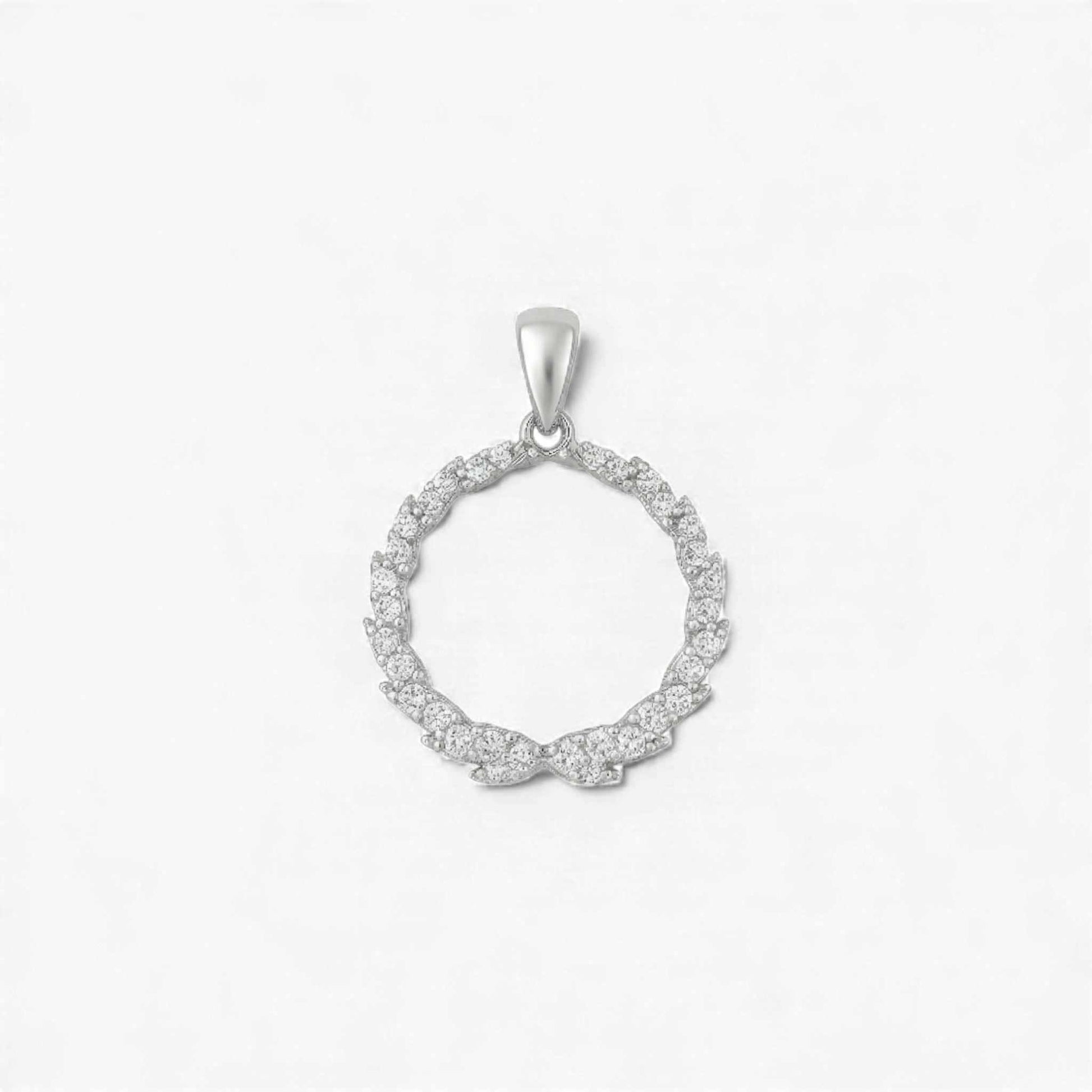 Silver circular pendant with small diamonds on a light gray background