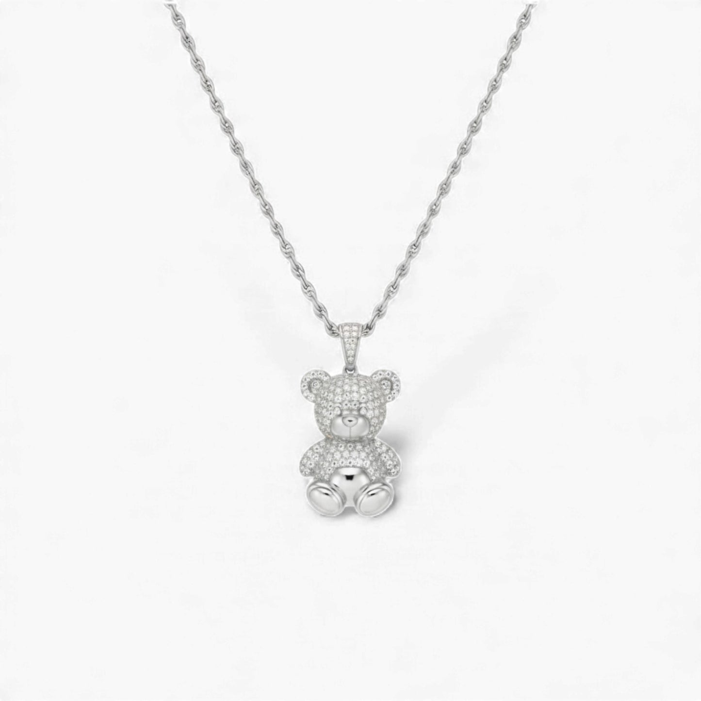Silver teddy bear pendant necklace on a white background