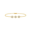Gold bracelet with three circular diamond-like elements on a white background