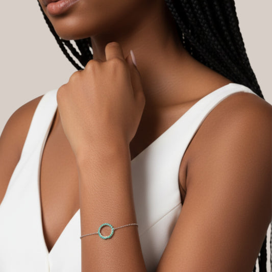 Woman wearing a bracelet on a neutral background