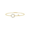 Gold bracelet with a key-shaped clasp on a white background