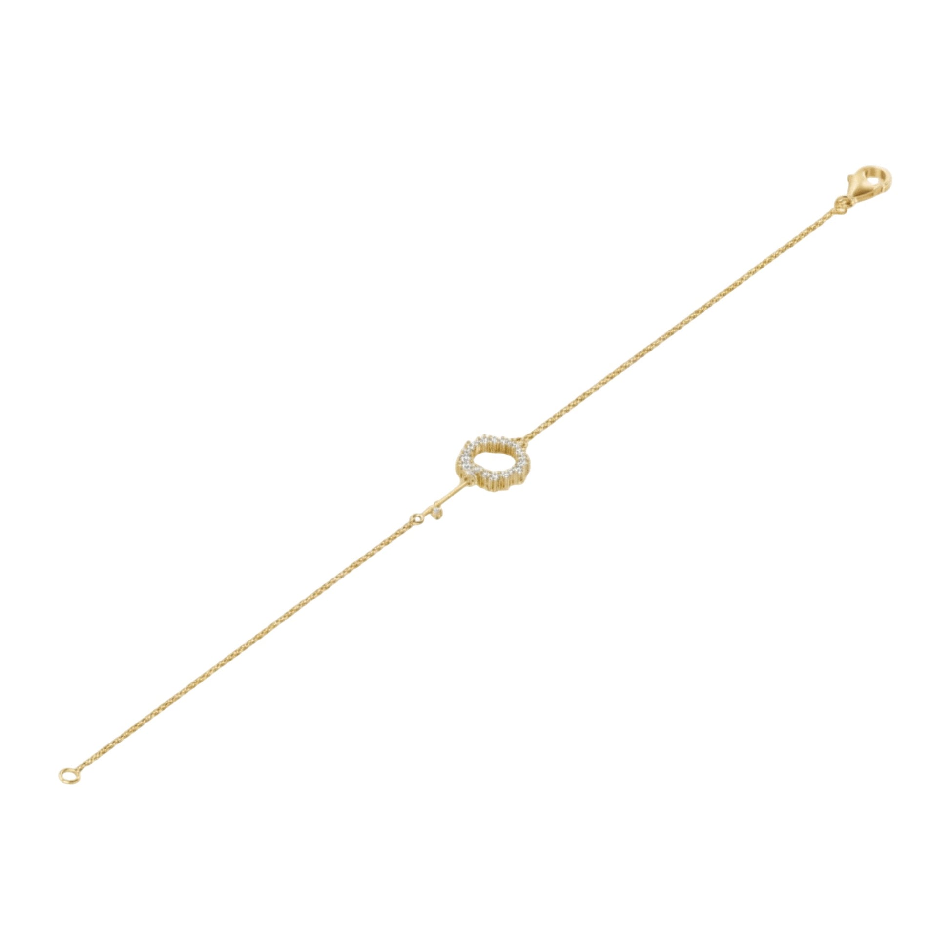 Gold bracelet with a circular clasp on a white background