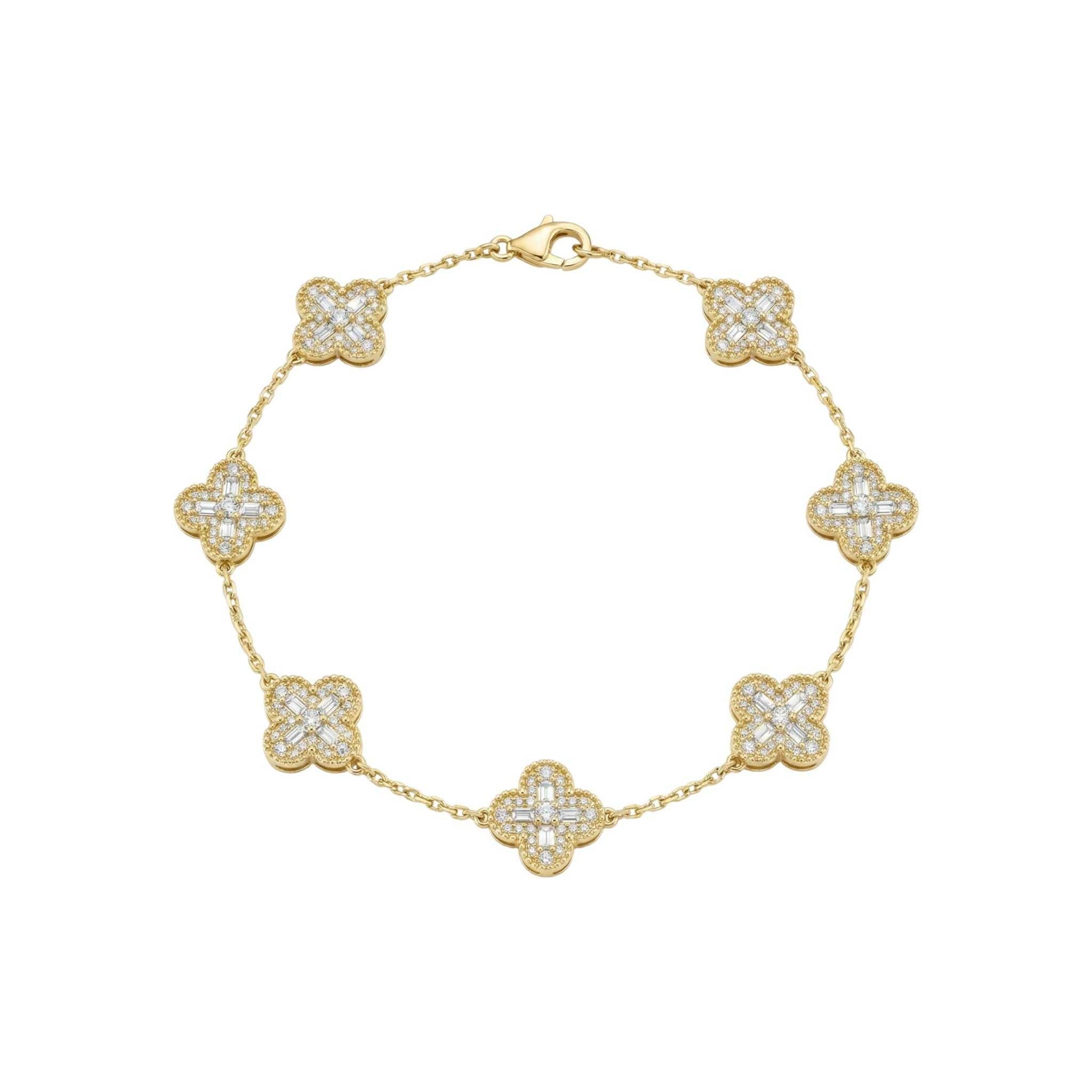 Gold bracelet with diamond-studded clover-shaped links on a white background
