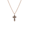 Rose gold cross necklace with black stones on a white background