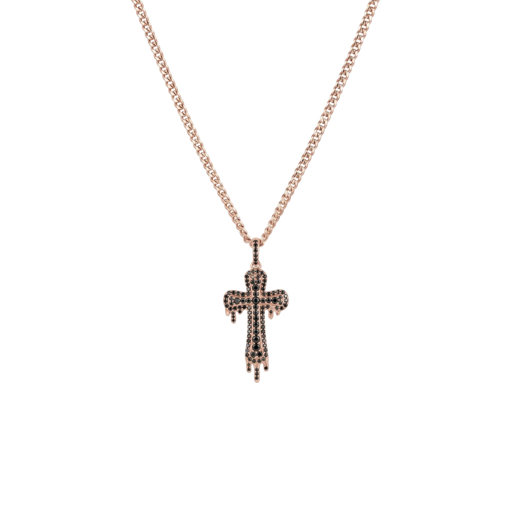 Rose gold cross necklace with black stones on a white background