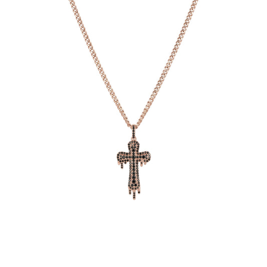 Rose gold cross necklace with black stones on a white background