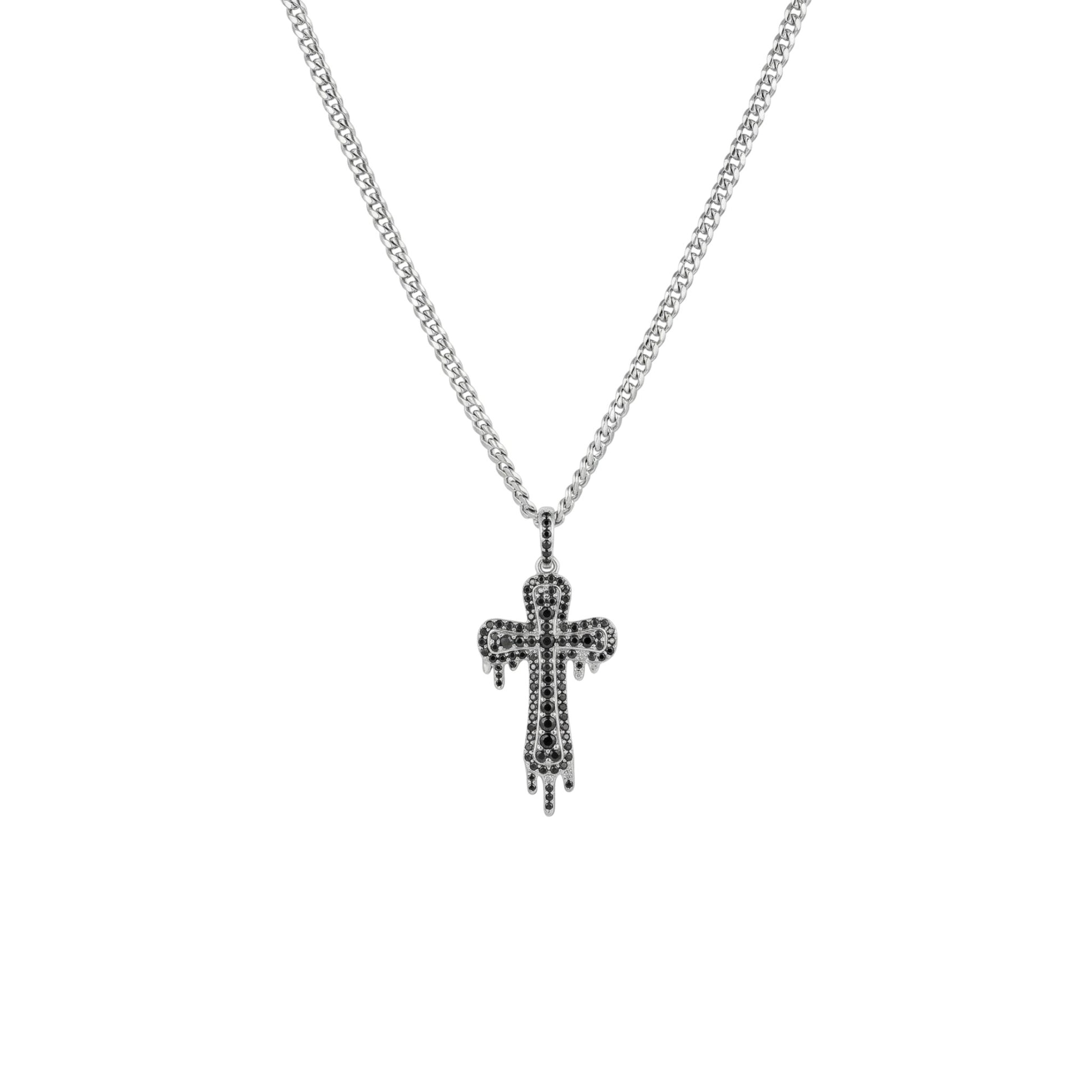 Silver cross necklace with black stones on a white background