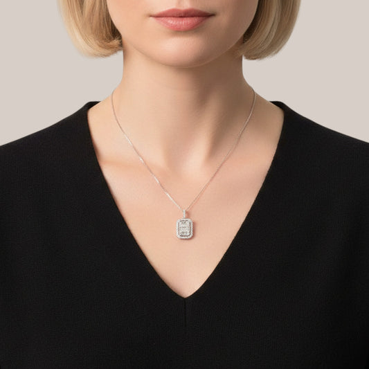 Necklace with a pendant worn by a person against a neutral background