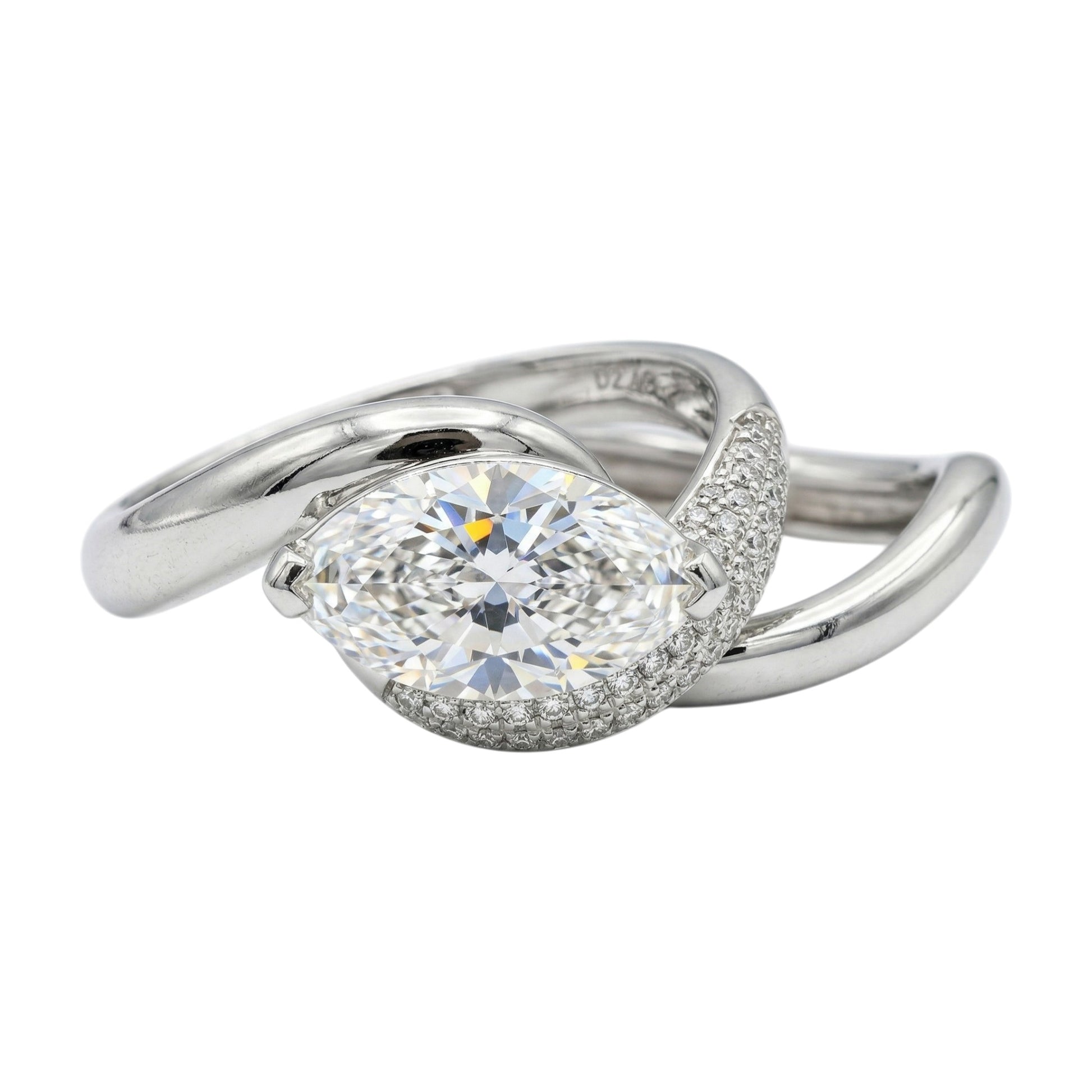 Silver ring with a large diamond on a white background
