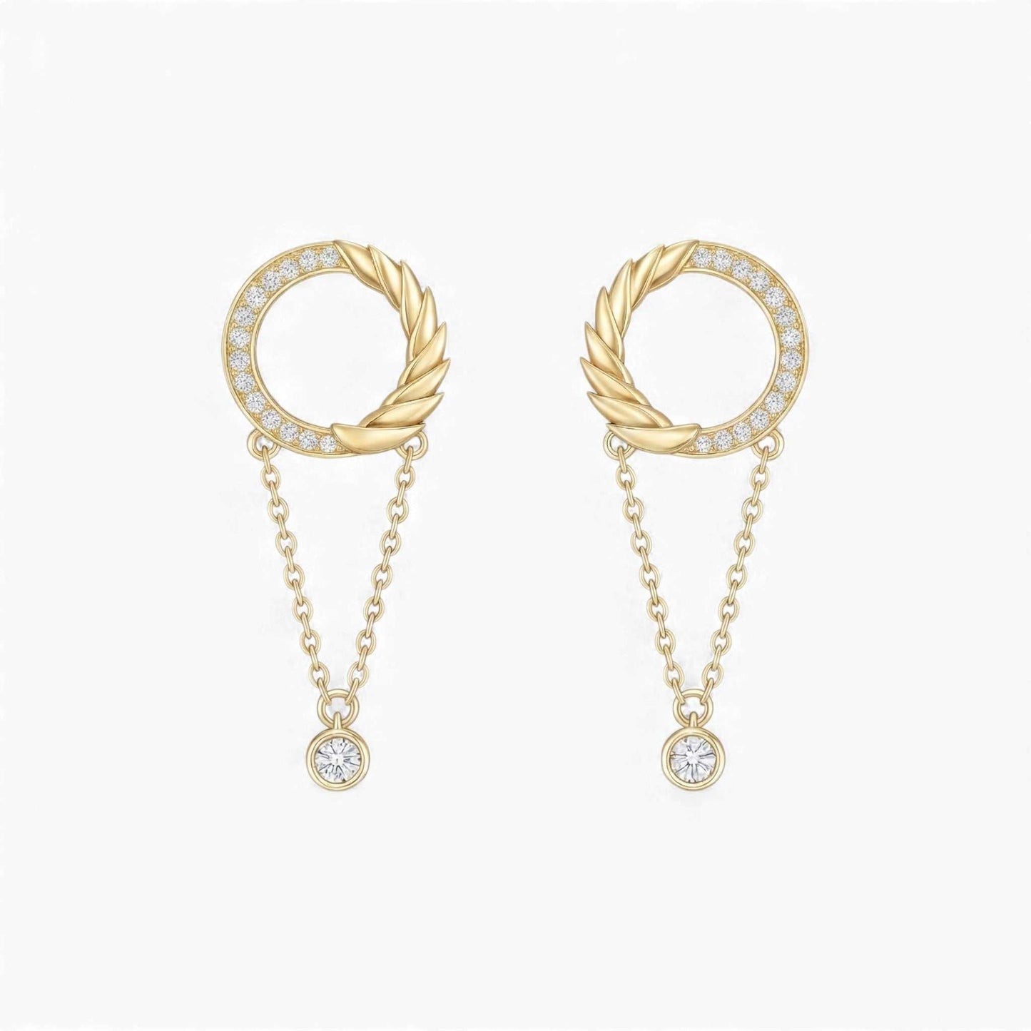 Gold earrings with circular designs and chain details on a white background