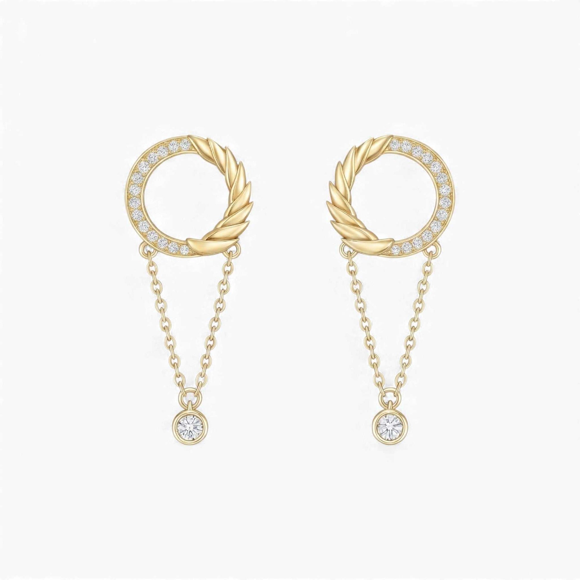 Gold earrings with circular designs and chain details on a white background