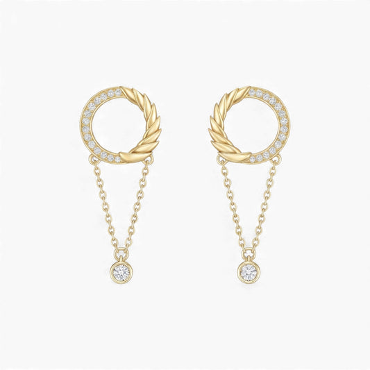 Gold earrings with circular designs and chain details on a white background