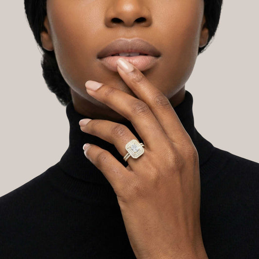Woman wearing a diamond ring on her hand with a neutral background