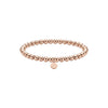 Rose gold beaded bracelet with a round tag on a white background