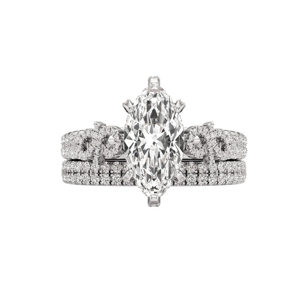 Diamond ring with a marquise-shaped center stone on a white background